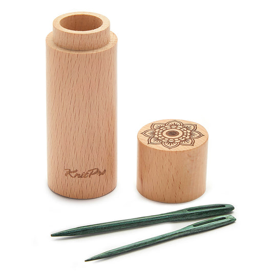 Four teal wooden darning needles beside a round wooden case