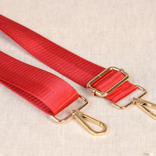 Two-Tone red bag shoulder strap with metal fastenings