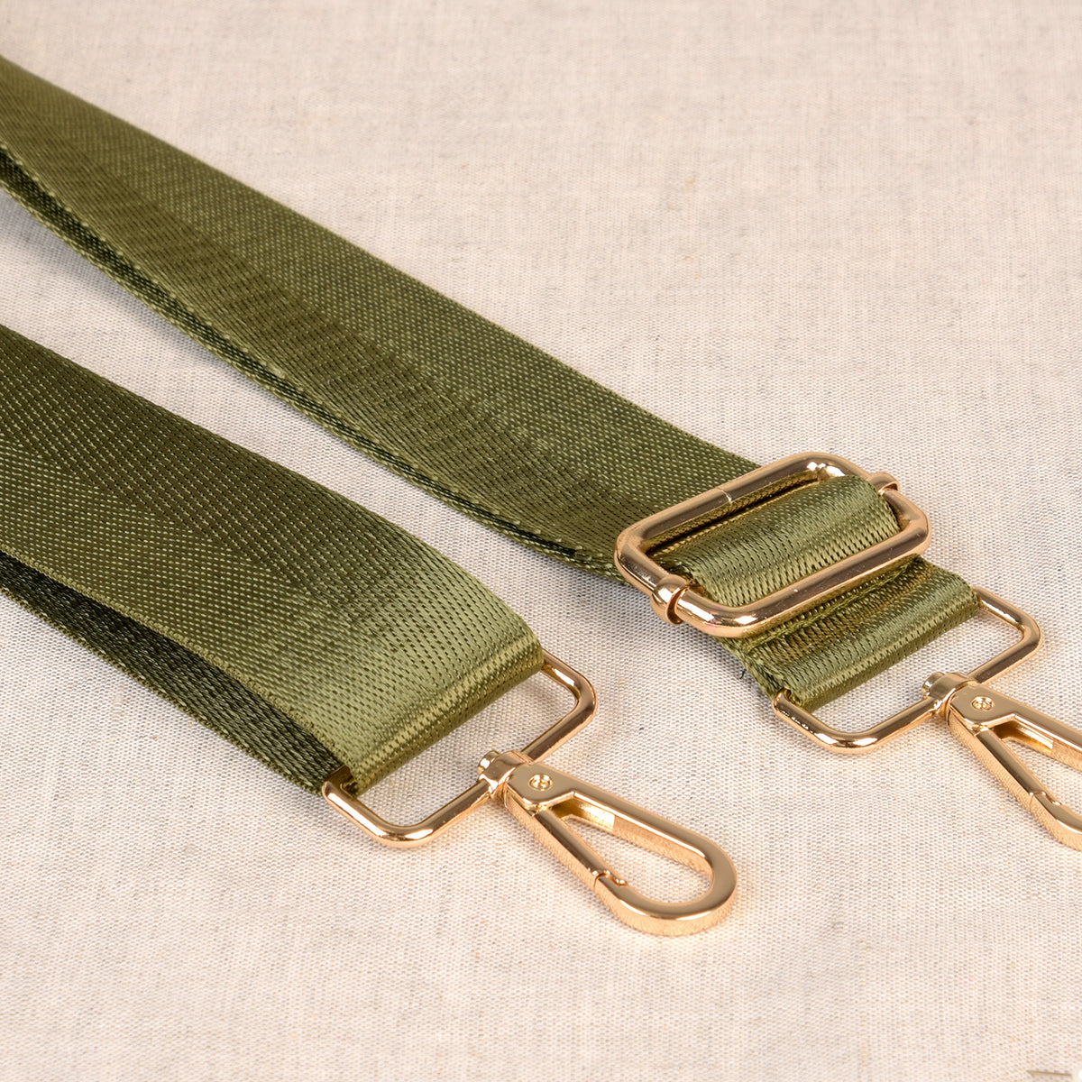 Two-Tone green bag shoulder strap with metal fastenings
