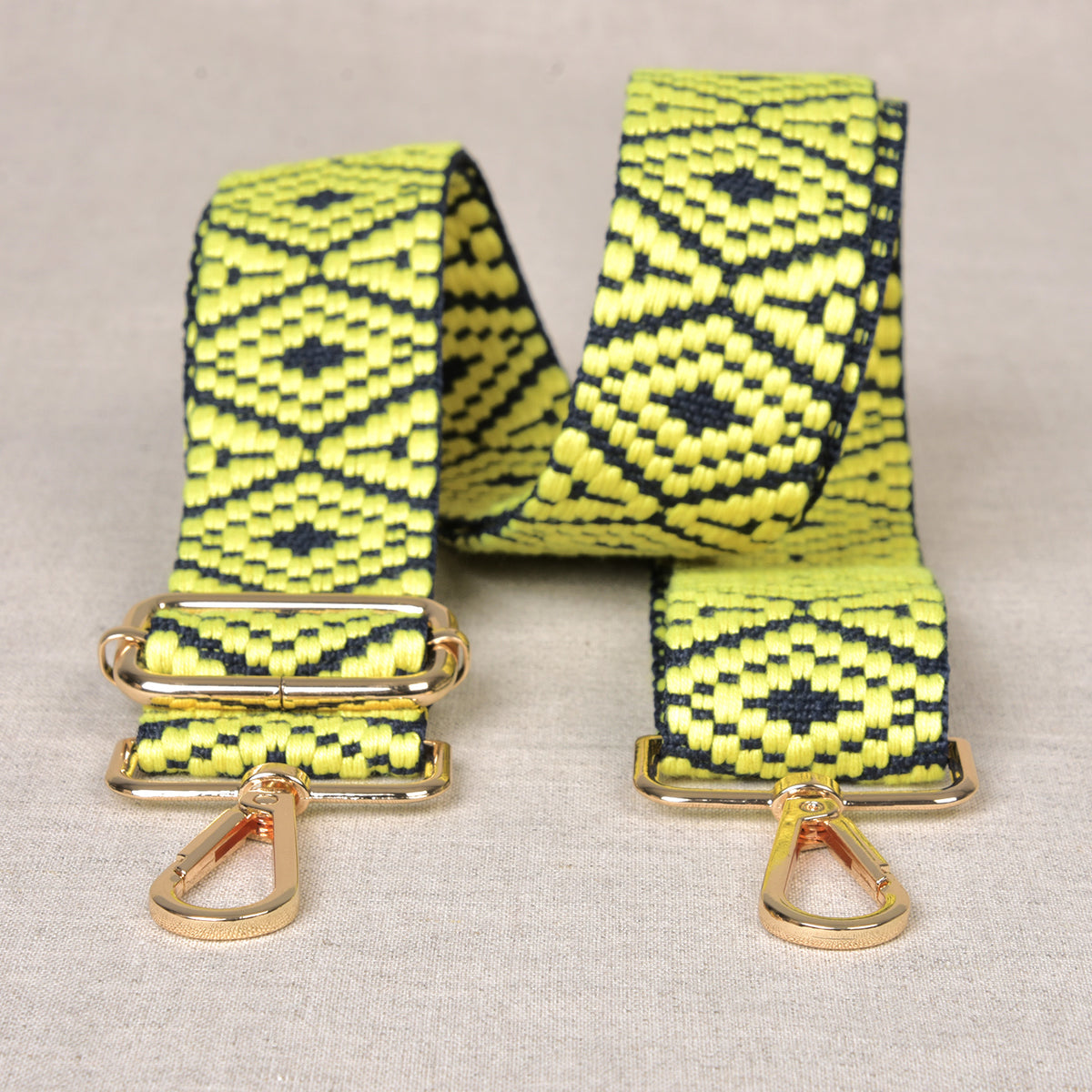 Printed yellow bag shoulder strap with metal fastenings