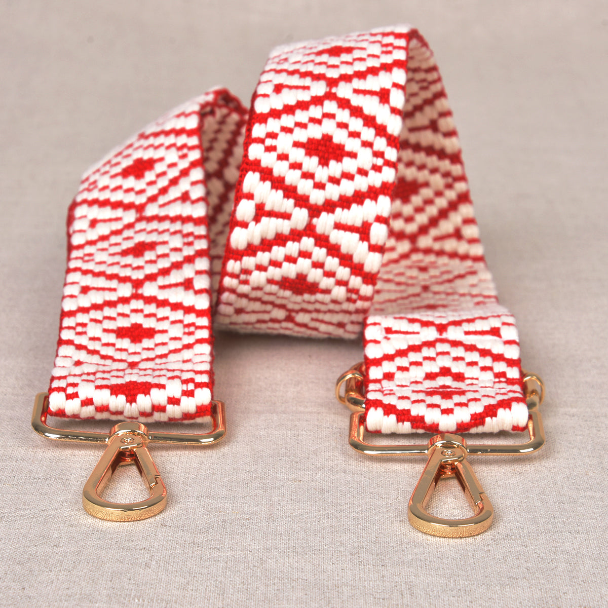 Printed red bag shoulder strap with metal fastenings