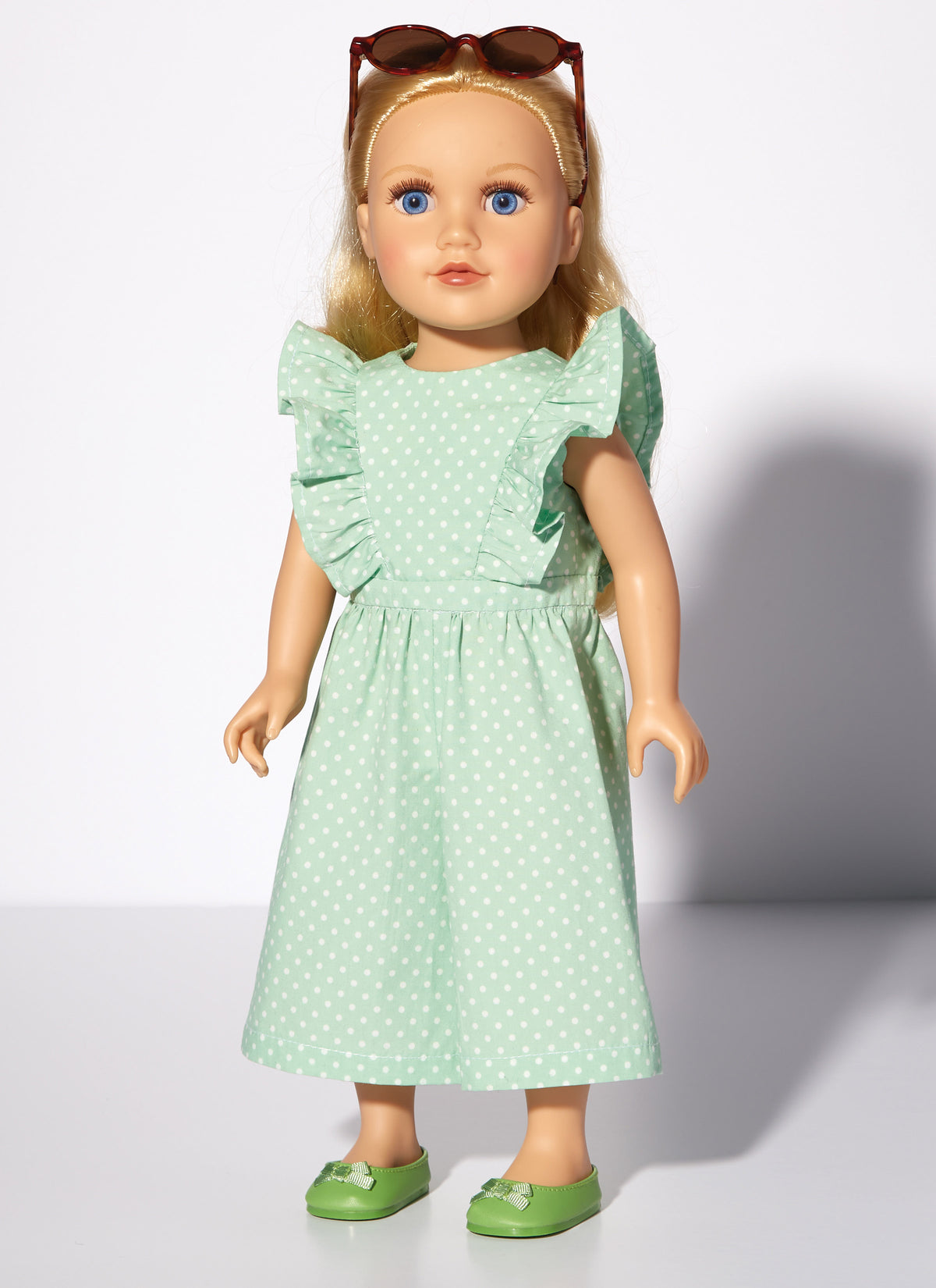 McCall's M8309 sewing pattern envelope showing spring and summer outfits for 18in dolls