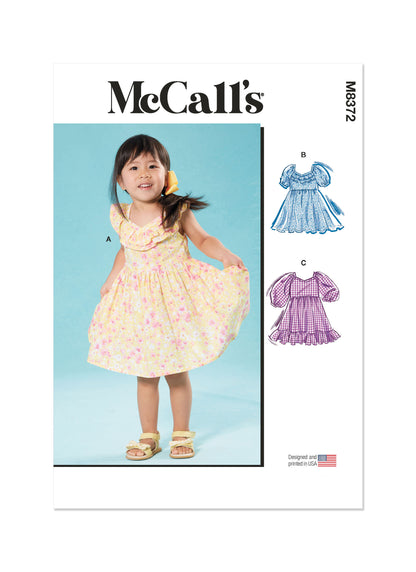 McCall's M8372 sewing pattern envelope showing knee-length toddler dresses