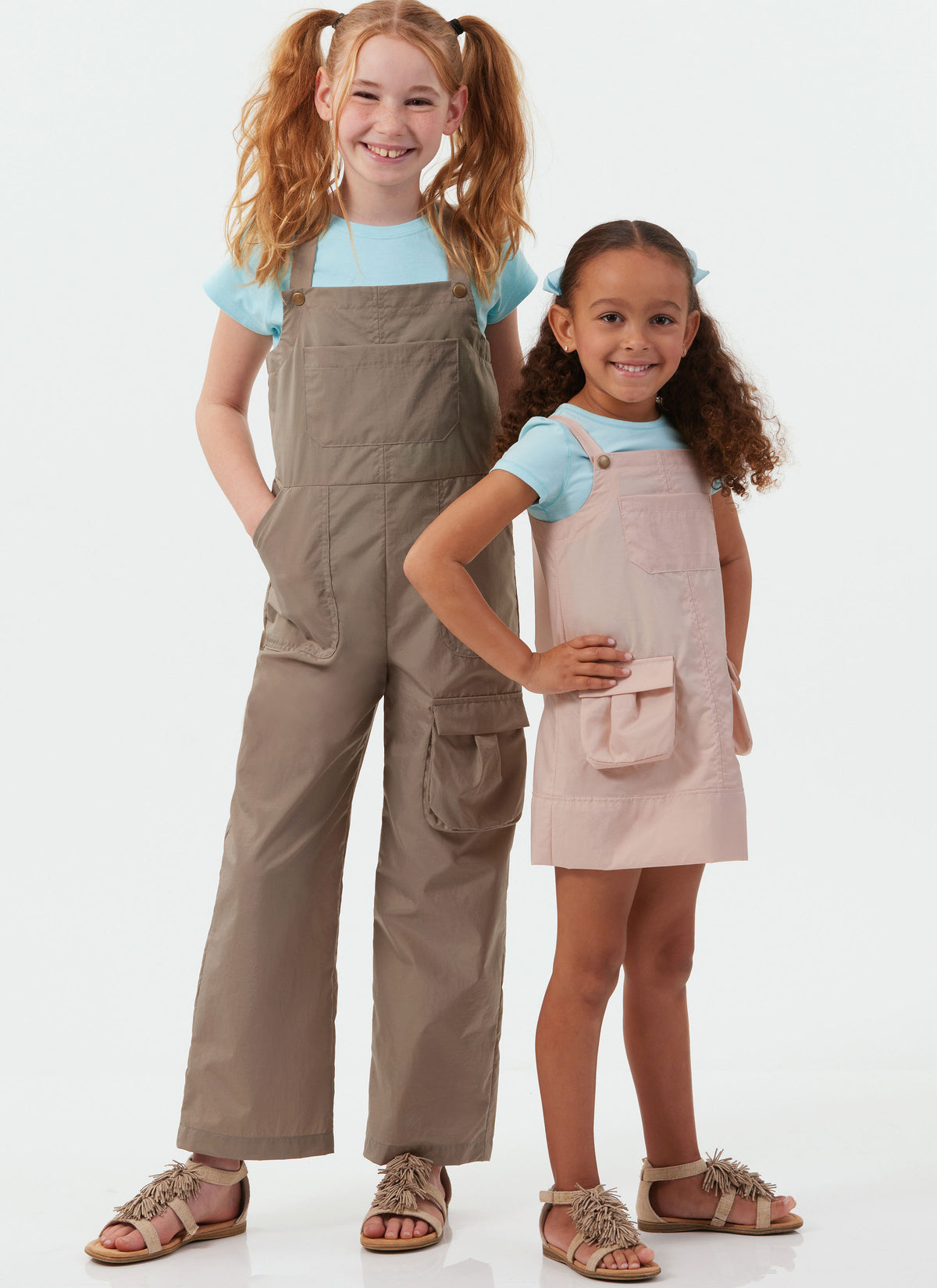 McCall's M8489 sewing pattern envelope showing girls' pinafore & overalls designs