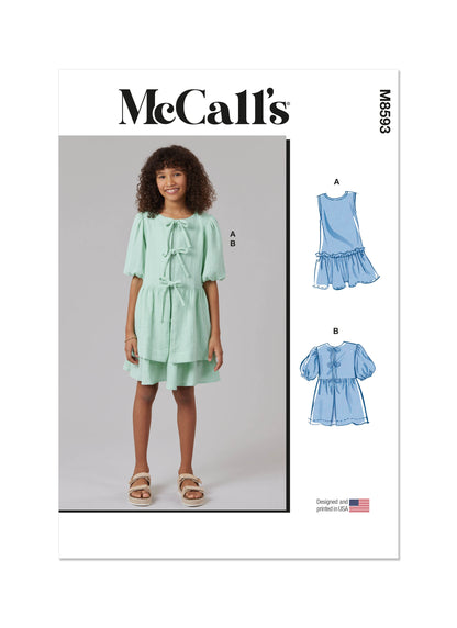 McCall's M8593 sewing pattern envelope showing girls' dress and top designs