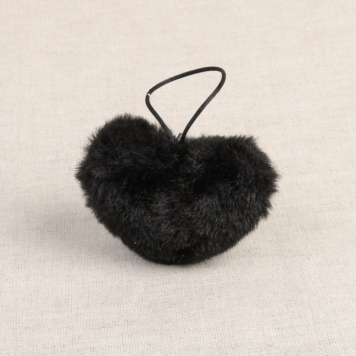 Black faux fur heart-shaped pom pom with loop