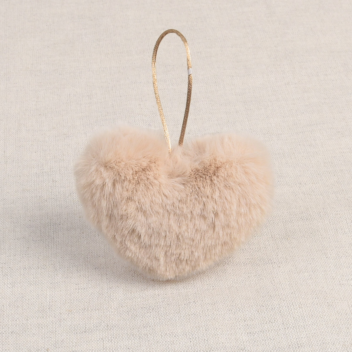 Ivory faux fur heart-shaped pom pom with a hanging loop