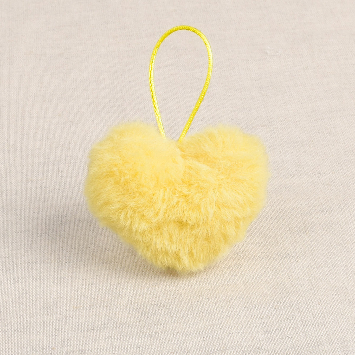 Neon Yellow faux fur heart-shaped pom pom with loop