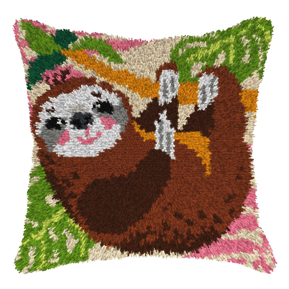 Finished Orchidea latch hook cushion showing a brown sloth hanging from a branch with green leaves