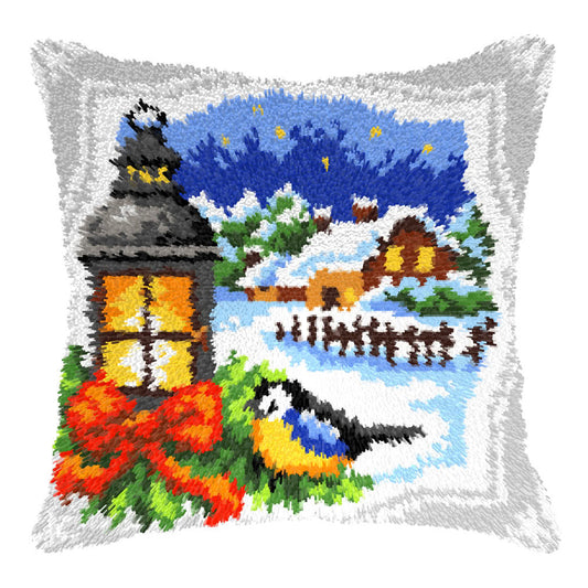 Finished Orchidea latch hook cushion showing a blue tit perched by a lantern