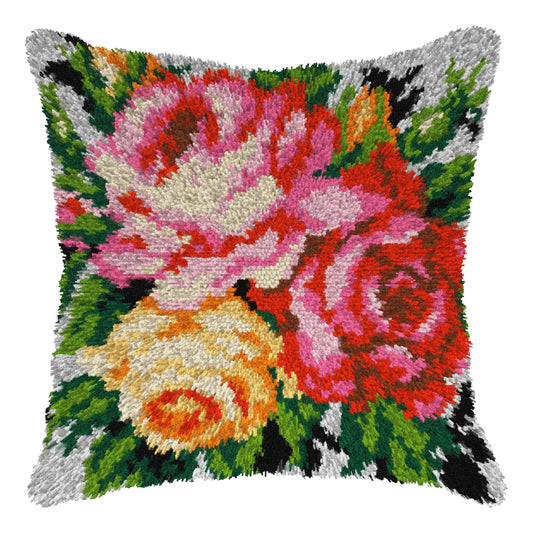 Finished Orchidea latch hook cushion showing a bunch of pink, red and yellow roses