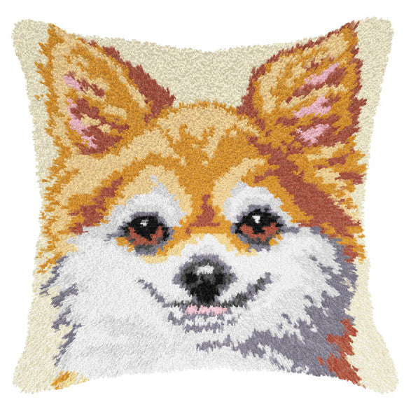 Finished Orchidea latch hook cushion showing a smiling ginger and white dog with pointed ears