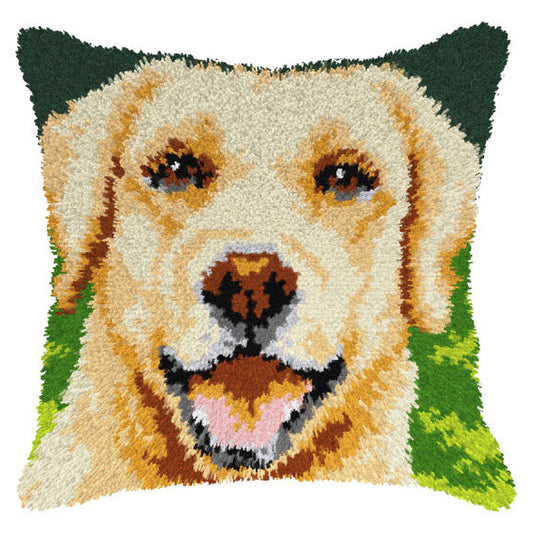 Finished Orchidea latch hook cushion showing a smiling golden-coated dog on a green background