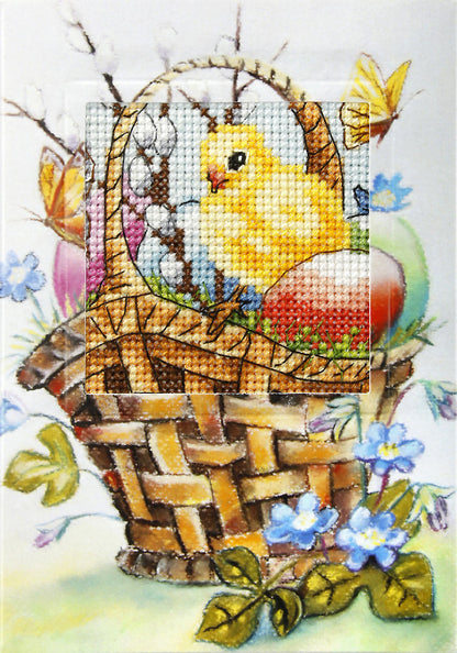 Cross stitch greetings card showing an Easter chick sitting in a basket