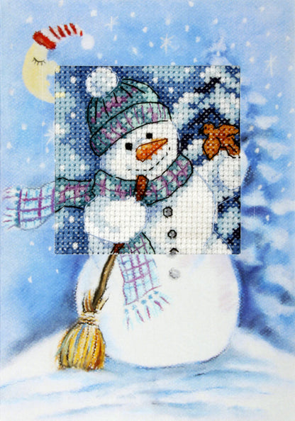 Cross stitch greetings card showing a snowman with a broom and scarf under a crescent moon