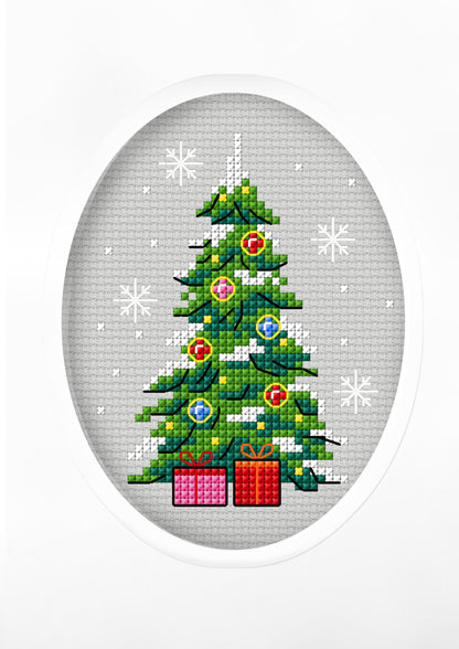 Cross stitch greetings card showing a decorated Christmas tree with presents in an oval frame