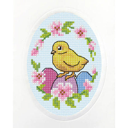 Cross stitch greetings card showing an Easter chick on light blue fabric