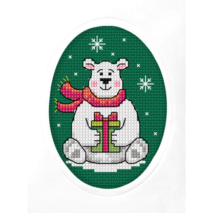 Cross stitch greetings card showing a Christmas bear on green fabric
