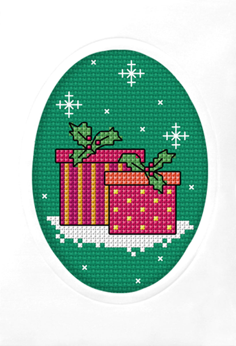 Cross stitch greetings card showing Christmas gifts on green fabric