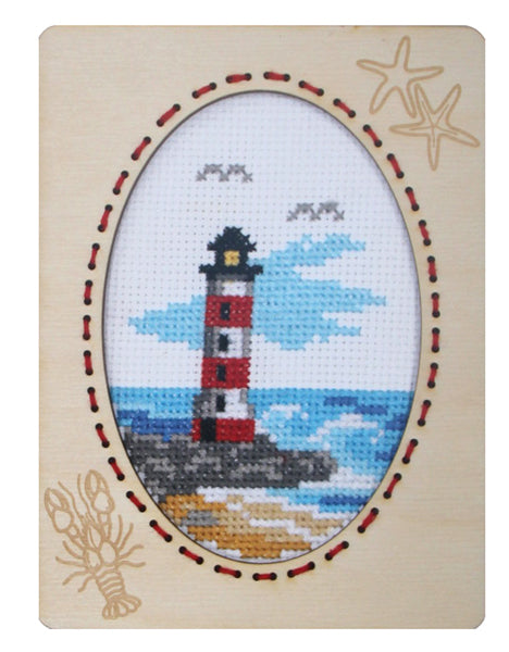 Orchidea cross stitch kit with a lighthouse design in an engraved wooden frame