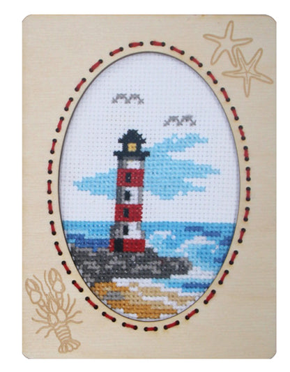 Orchidea cross stitch kit with a lighthouse design in an engraved wooden frame