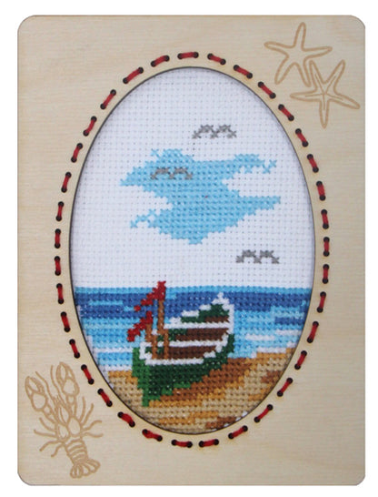 Orchidea cross stitch kit with a rowing boat design in an engraved wooden frame