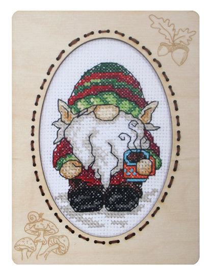 Orchidea cross stitch kit with a gonk design in an engraved wooden frame