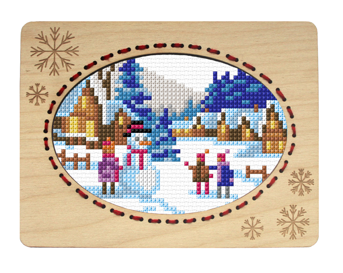 Orchidea landscape with snowman cross stitch in an engraved plywood frame
