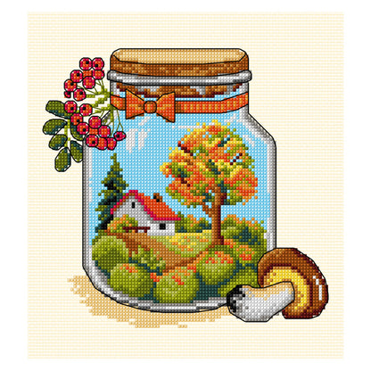 Cross stitch picture of a glass jar with autumn themed contents