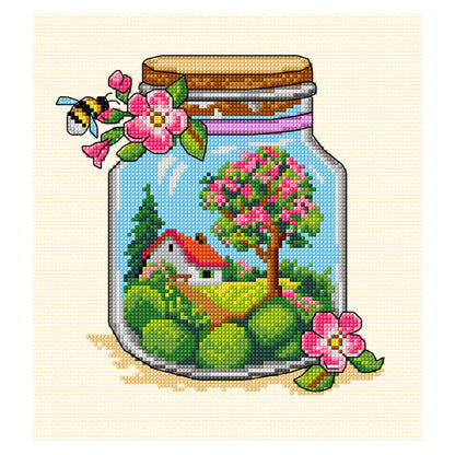 Cross stitch picture of a glass jar with spring themed contents