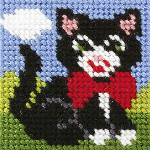 Finished beginner's needlepoint picture showing a kitten