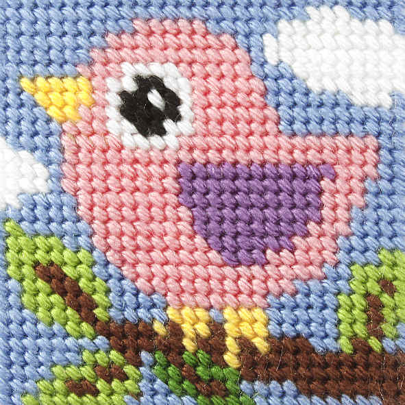 Finished beginner's needlepoint picture showing a bird