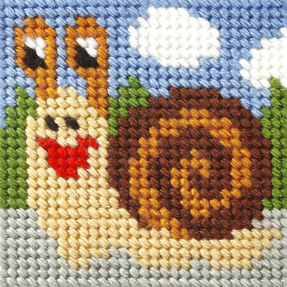 Finished beginner's needlepoint picture showing a snail