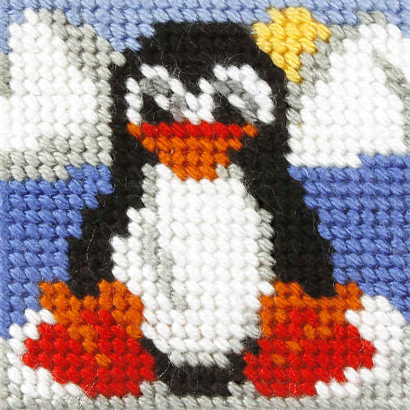 Finished beginner's needlepoint picture showing a penguin