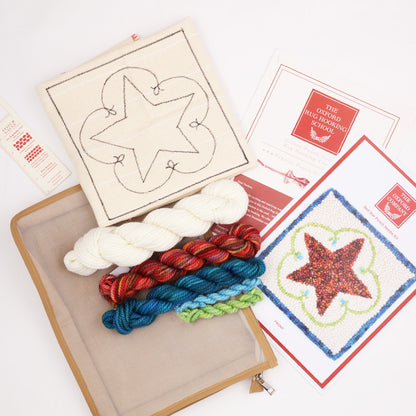 Finished red star punch needle design in wool yarn