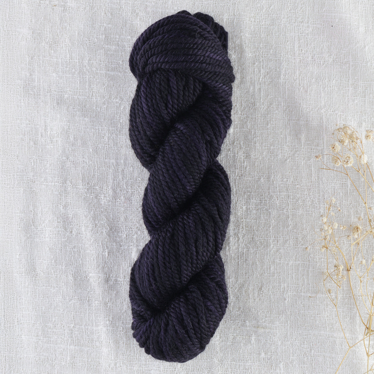 Skein of variegated Blackberry rug weight punch needle wool yarn
