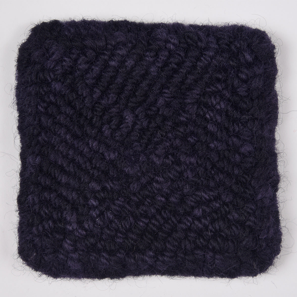 Skein of variegated Blackberry rug weight punch needle wool yarn