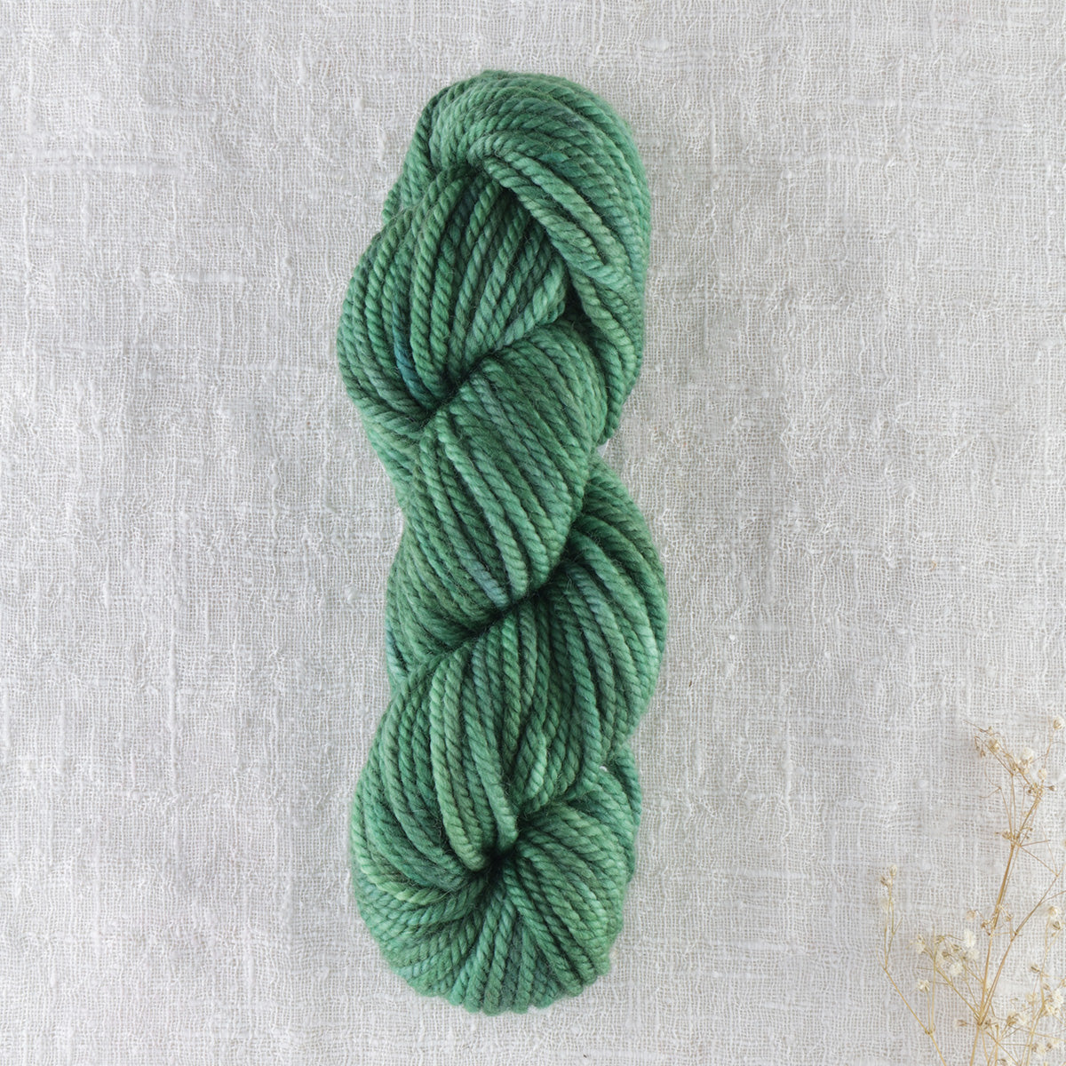 Skein of variegated Club Moss Light rug weight punch needle wool yarn