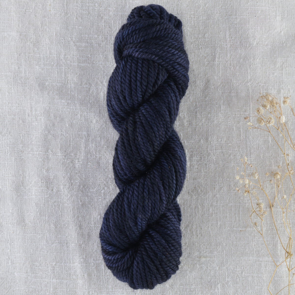 Skein of variegated Blackbird rug weight punch needle wool yarn