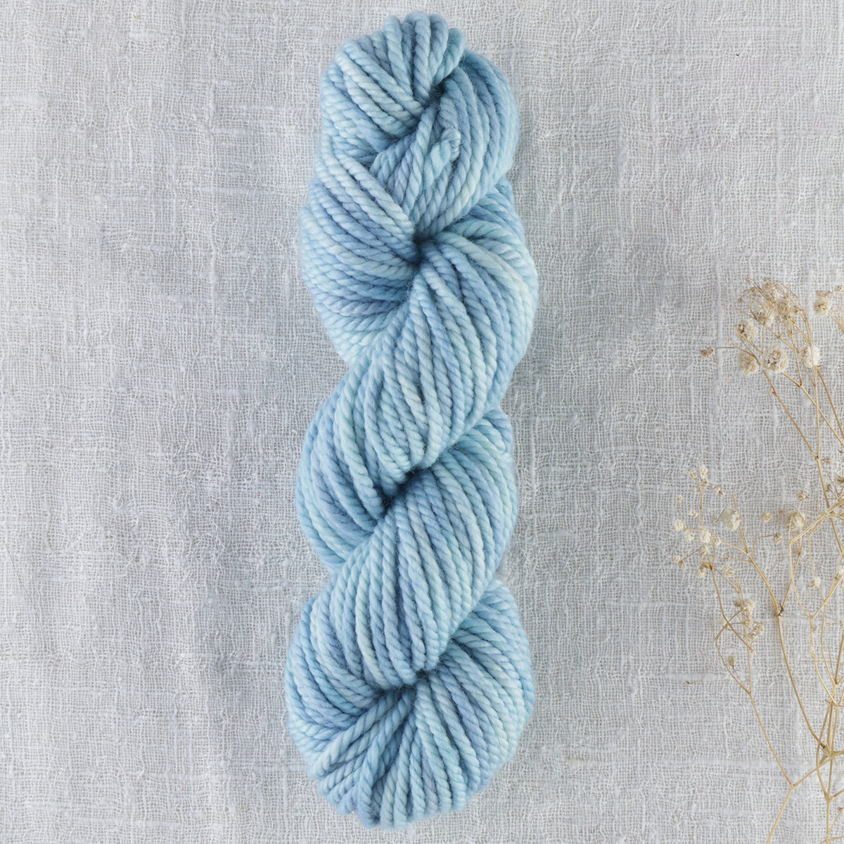 Skein of variegated Eye On The Sky rug weight punch needle wool yarn