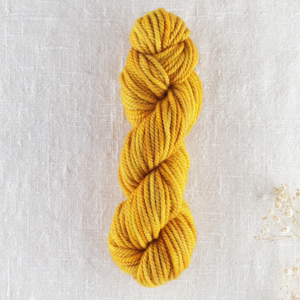 Skein of variegated Golden Ticket rug weight punch needle wool yarn