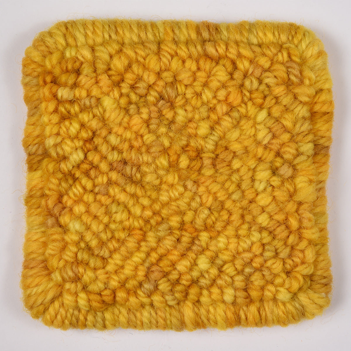 Skein of variegated Golden Ticket rug weight punch needle wool yarn