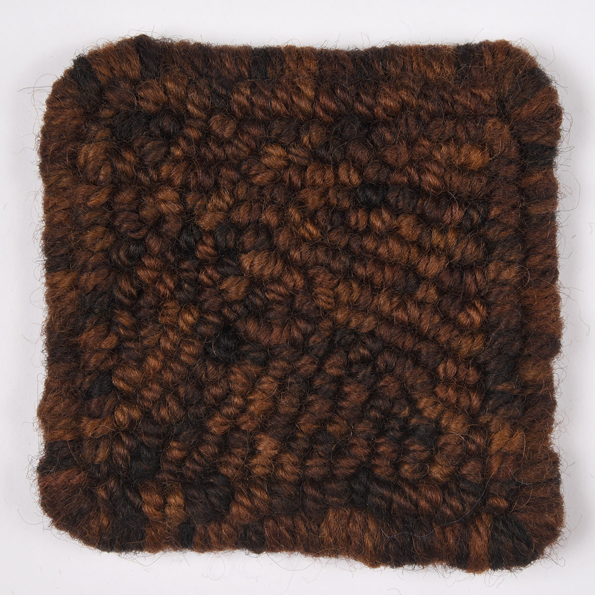 Skein of variegated Dark Roast rug weight punch needle wool yarn