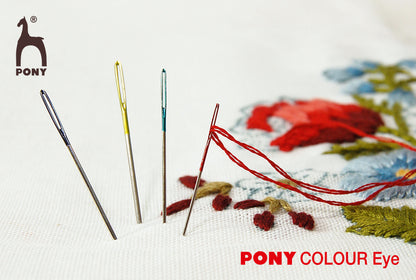 Pony crewel needles with coloured eyes in a round compact