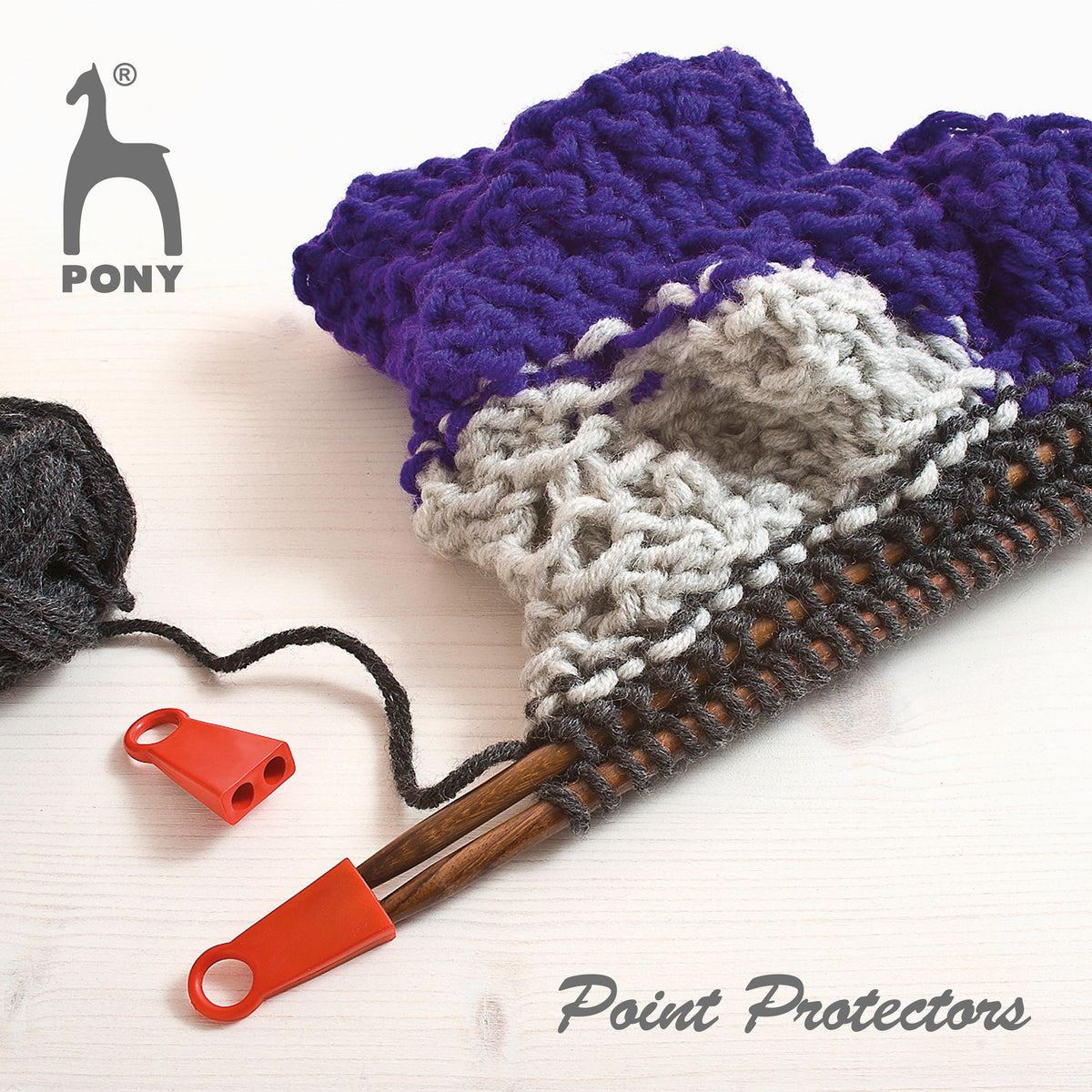 Red Pony jumbo point protector on a knitting needle