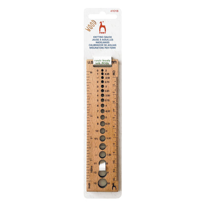 Rectangular wooden knitting gauge with needle holes and ruler markings
