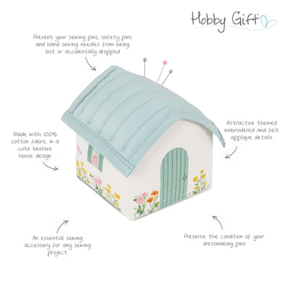 Cottage shaped pincushion with embroidered flowers