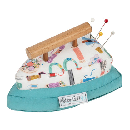 Iron-shaped fabric pincushion with a wooden handle