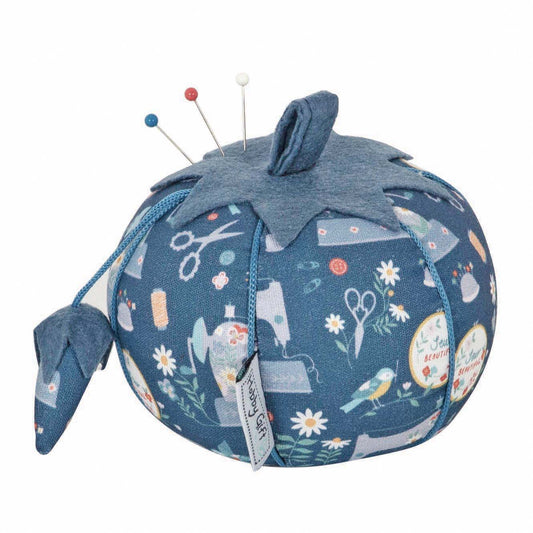 Tomato pincushion in a sewing machine print fabric