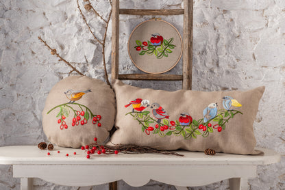 Round embroidered cushion with vintage bird design